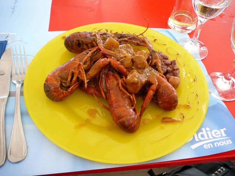 Lobster on a yellow plate served at lunch at Petitbonum restaurant in Martinique.