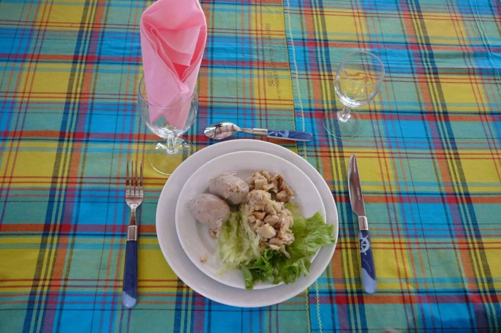A white plate with a typical Martinique breakfast on a madras tablecloth.