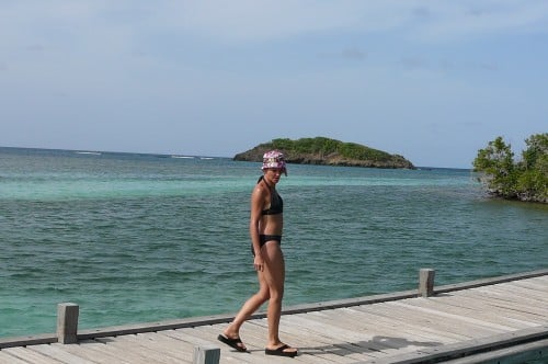 Woman in bathing suit on a dock at Ilet Madame in Martinique. 