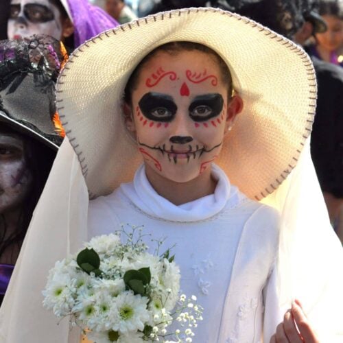 A young girl dressed as a catrina on Day of the Dead in Mexico.