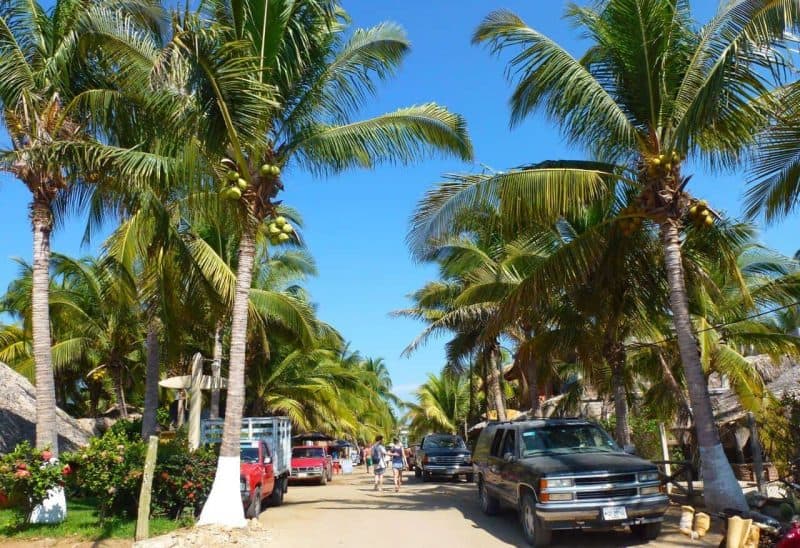 Main Street lined with cars in La Punta, Puerto Escondido, Mexico.