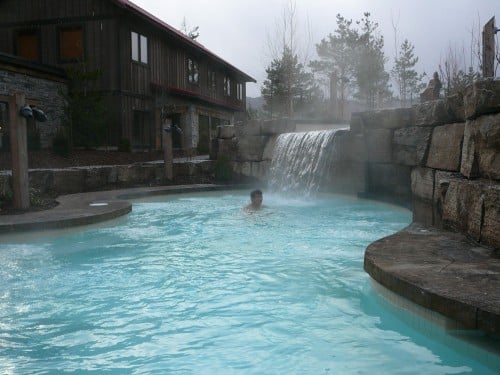 Man swimming in water at Scandinave Spa Blue Mountain. 