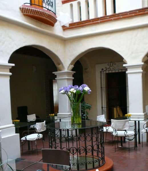 Chairs and pillars of interior courtyard at Casa Catrina hotel in Oaxaca City Mexico.