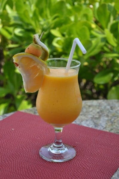 Mango margarita cocktail on a pink tablecloth. 