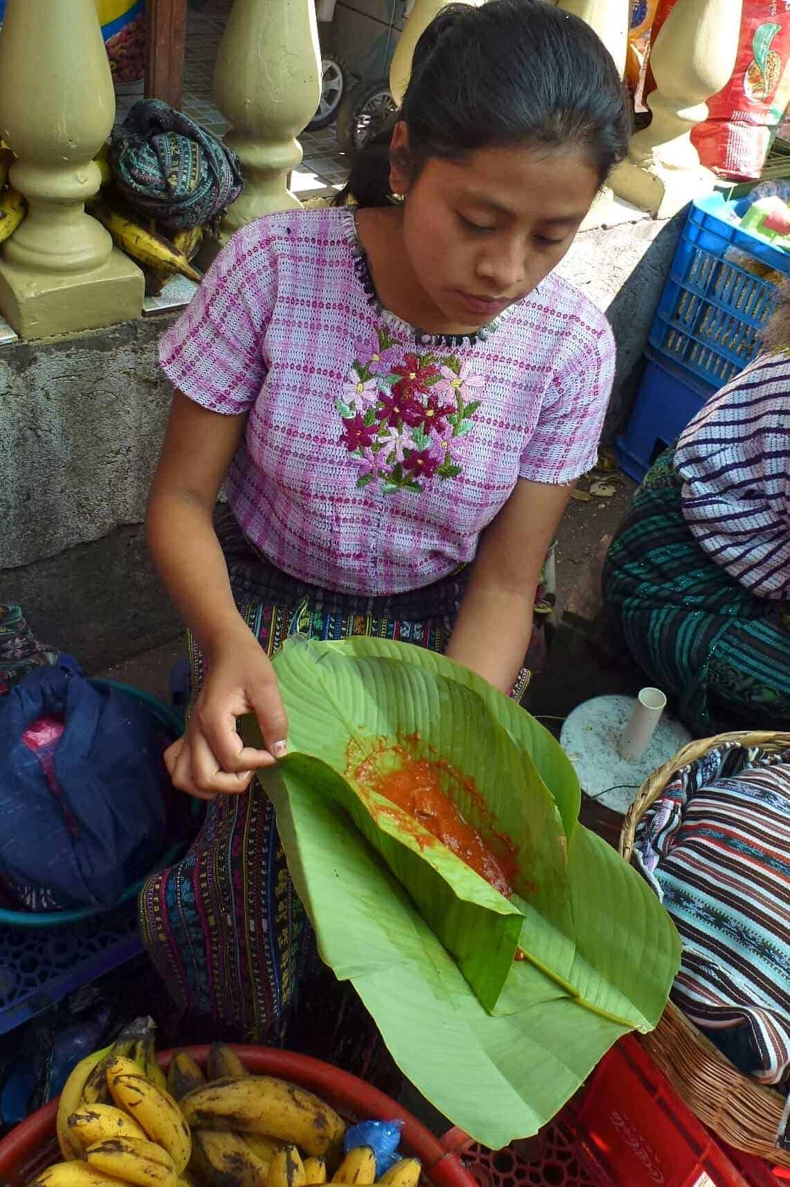 Vendor in the Santiago Atitlan market with patin wrapped in hoja de maxán