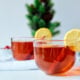 Hot Bourbon Toddy with lemon garnish on a white table.