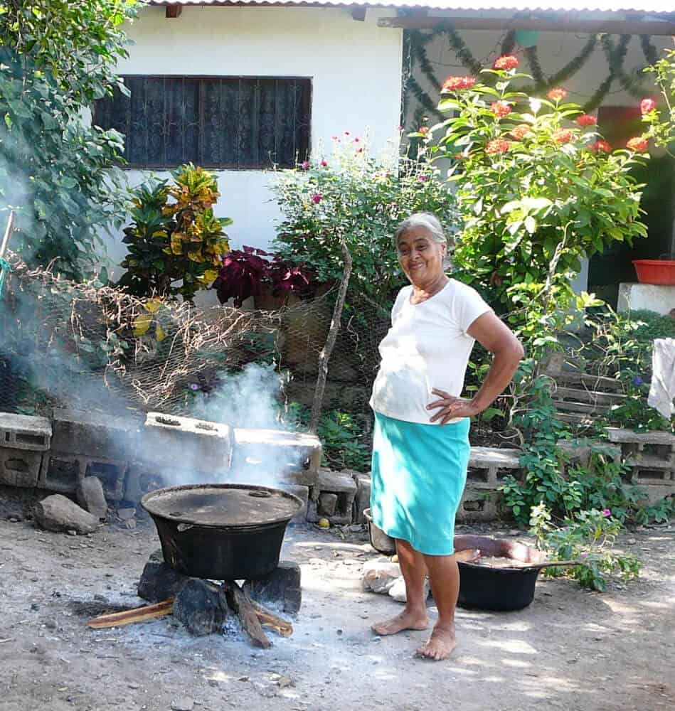 Tia Maria tending her pot of tamales in San Vicente