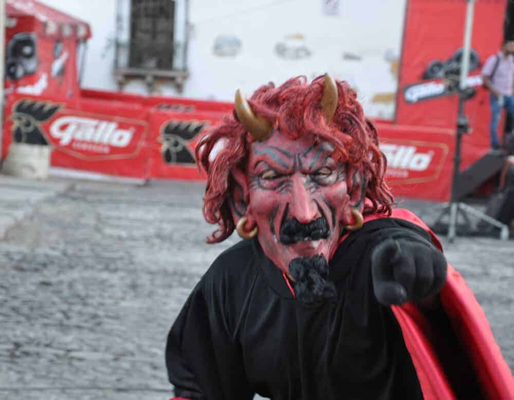 Costumed reveller on dia del diablo, prior to la quema del diablo in Antigua, Guatemala. 