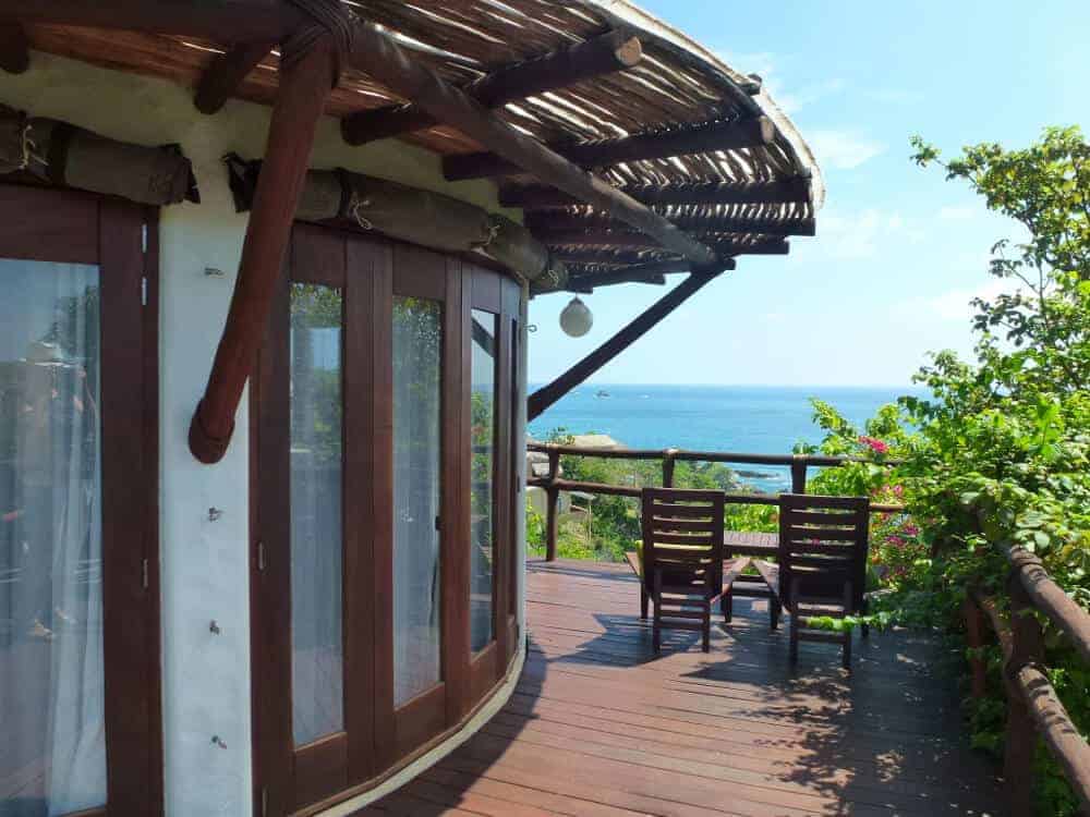 A circular bungalow with a palapa roof at Zoa Resort in Mazunte Mexico. 