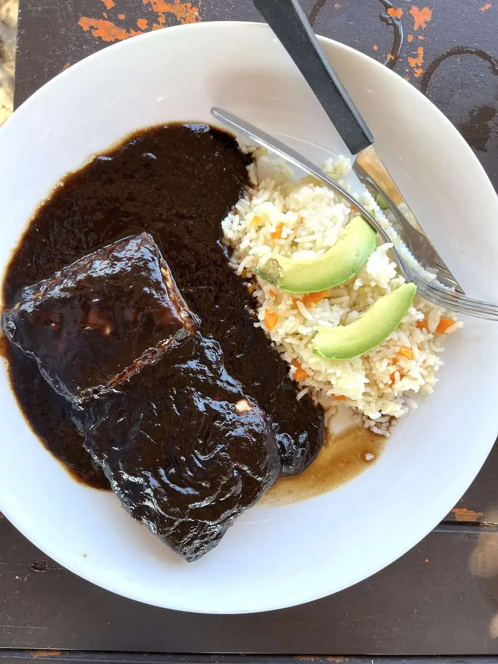 Madrigal fish in tamarind sauce on a white plate. 