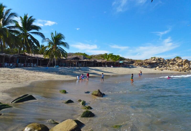 Children swimming at Roca Blanca Beach in Oaxaca Mexico 