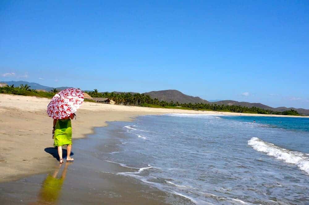 Woman walking on Roca Blanca Beach near Puerto Escondido. 