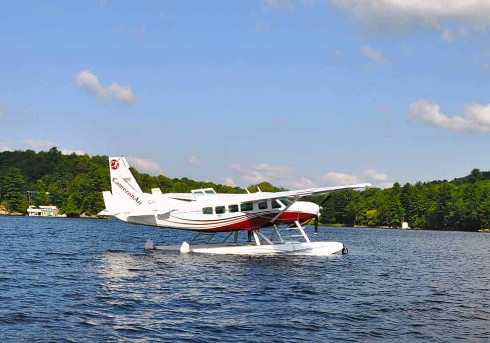 A Cameron Air float plane landing on the water in Muskoka. 