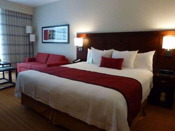 Bed and chair in a guest room at Courtyard Mexico City Airport Hotel.