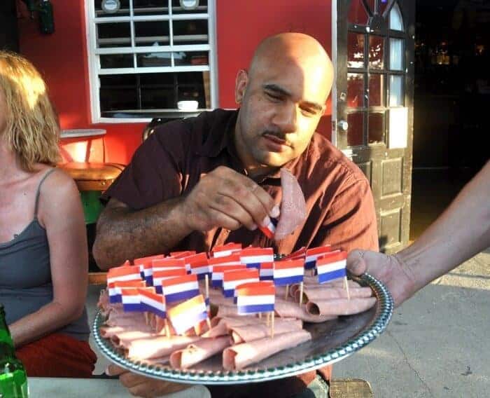 Man eating Dutch snacks at Cafe 080 Aruba.