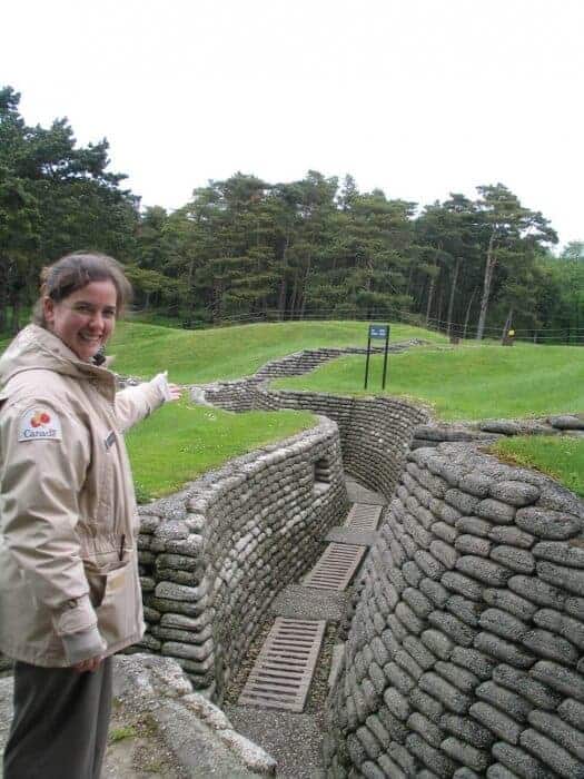 Guide pointing to a Vimy Ridge trench.