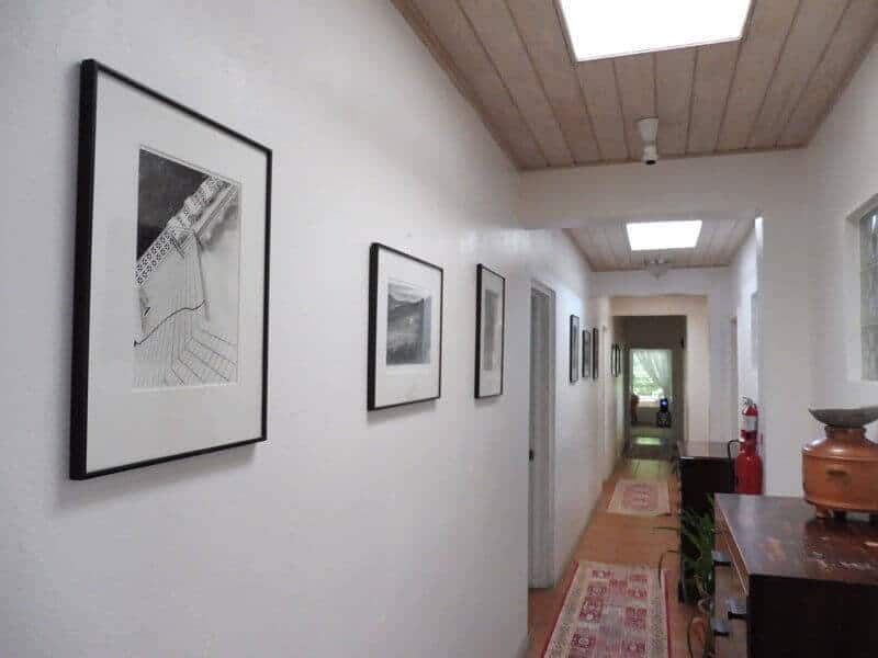 Hallway at Olveston House with photos by Linda McCartney.