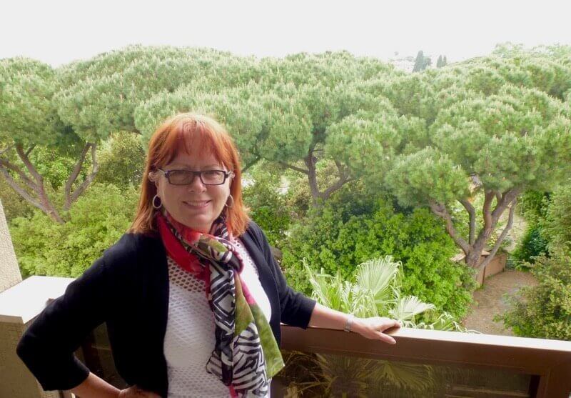 Michele Peterson on balcony in front of Villa Borghese Park at Parco dei Principe Hotel in Rome.