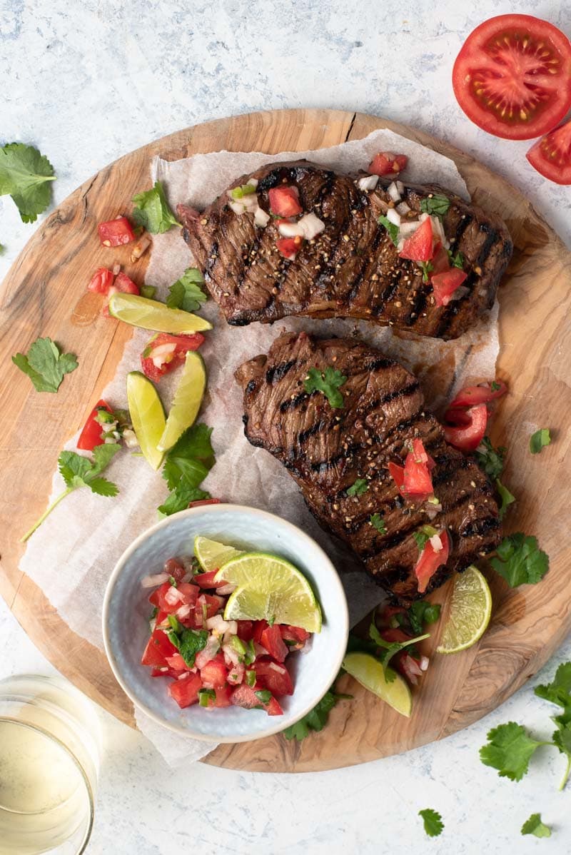 Grilled Steak in a beer and balsamic marinade served with a salsa fresca of tomatoes, onions, cilantro and lime