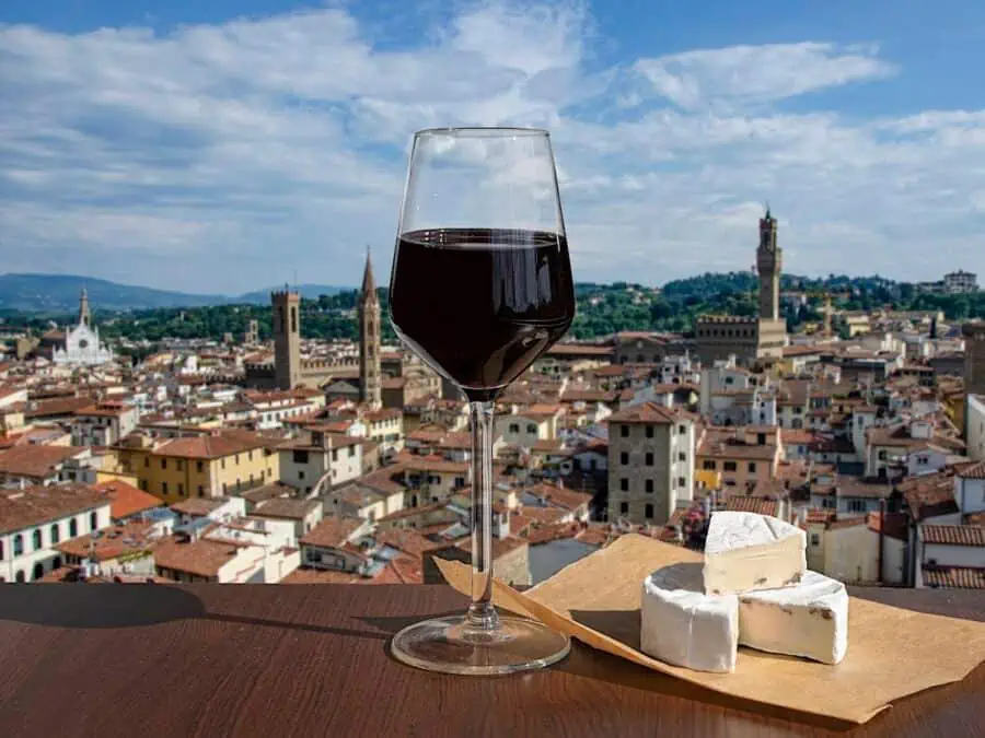 Glass of Chianti wine and cheese with view of skyline in Florence. in Italy
