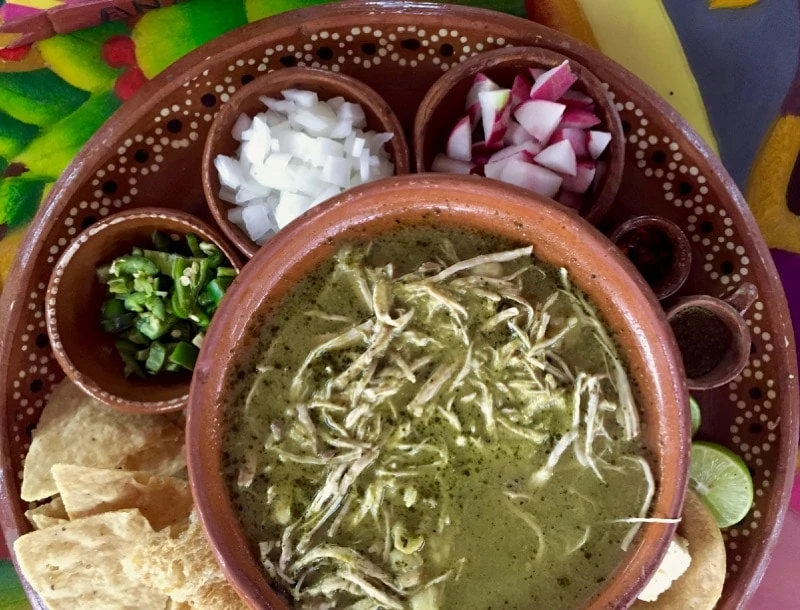 A pottery bowl of pozole at Any's in Zihuatanejo for Day of the Dead food.