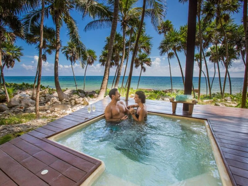 Couple in a plunge pool at Mi Amor hotel in Tulum Mexico.