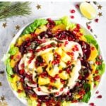 Ensalada de Nochebuena in a bowl on a white table.