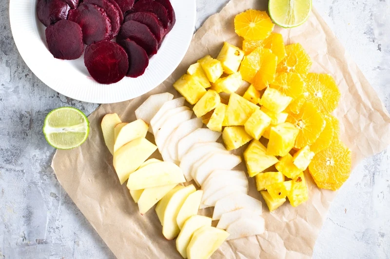 Chopped fresh vegetables including beets, apples, jicama, pineapple and orange for ensalada de noche buena.