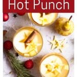 Mugs of hot fruit punch with text overlay for Pinterest of Christmas Hot Fruit Punch. for