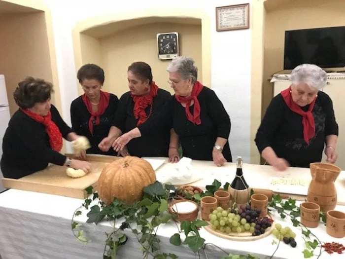 Women making orecchiette pasta for the Festival of San Martino in Taviano
