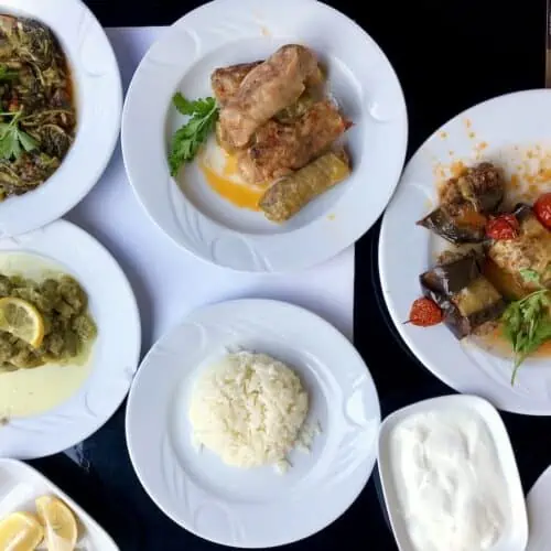 An overhead shot of traditional Turkish food and white rice on white plates in Turkey. shes