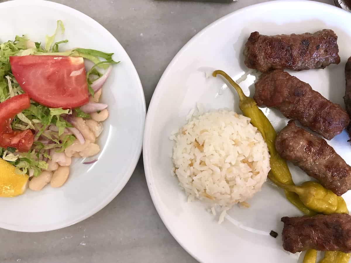 Two plates of Turkish food on white plates.