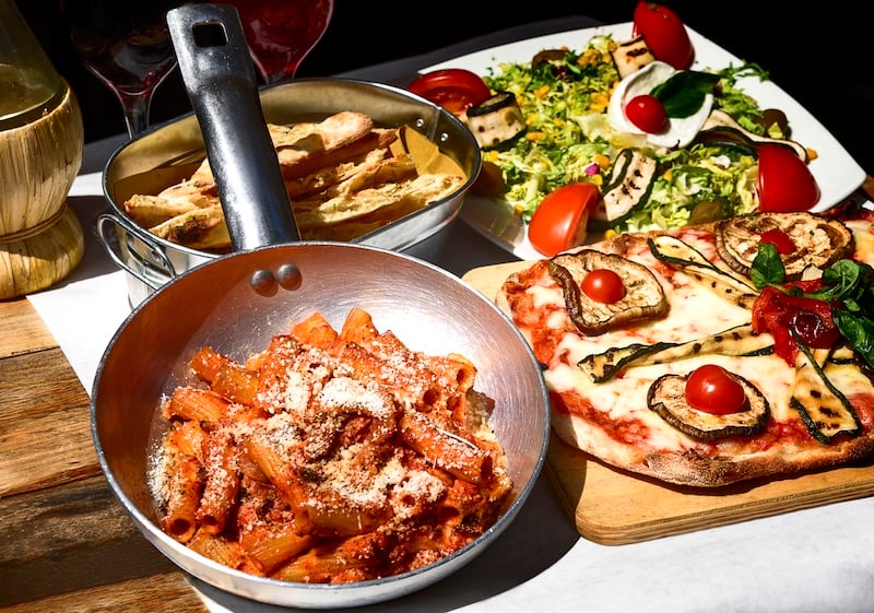 A skillet, salad and other famous Italian food to try on a food walking tour in Italy. Credit Deposit Photos