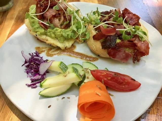 Bagel topped with guacamole and bacon at breakfast at Elephant Garden Puerto Escondido.