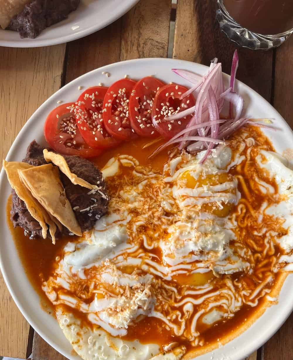 Eggs bathed in salsa de chilaquiles.