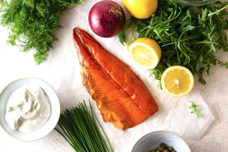 A Smoked Rainbow Trout with lemon, capers, chives, red onion, lemon, horseradish and sour cream. 