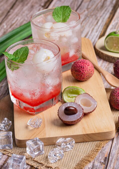 Lychee juice in a cocktail on a wooden board. 