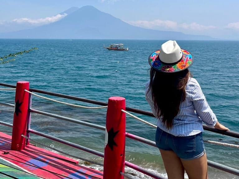 Young woman looking at Lake Atitlan in Panajachel, Solola, Guatemala.
