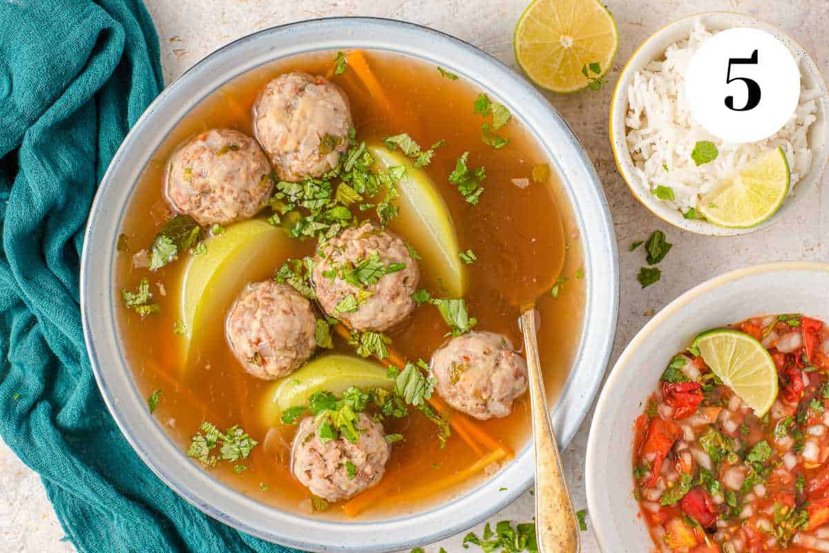 Turkey meatball soup keto in a white bowl on the table.