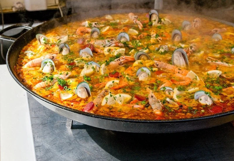 closeup of paella simmering in a pan