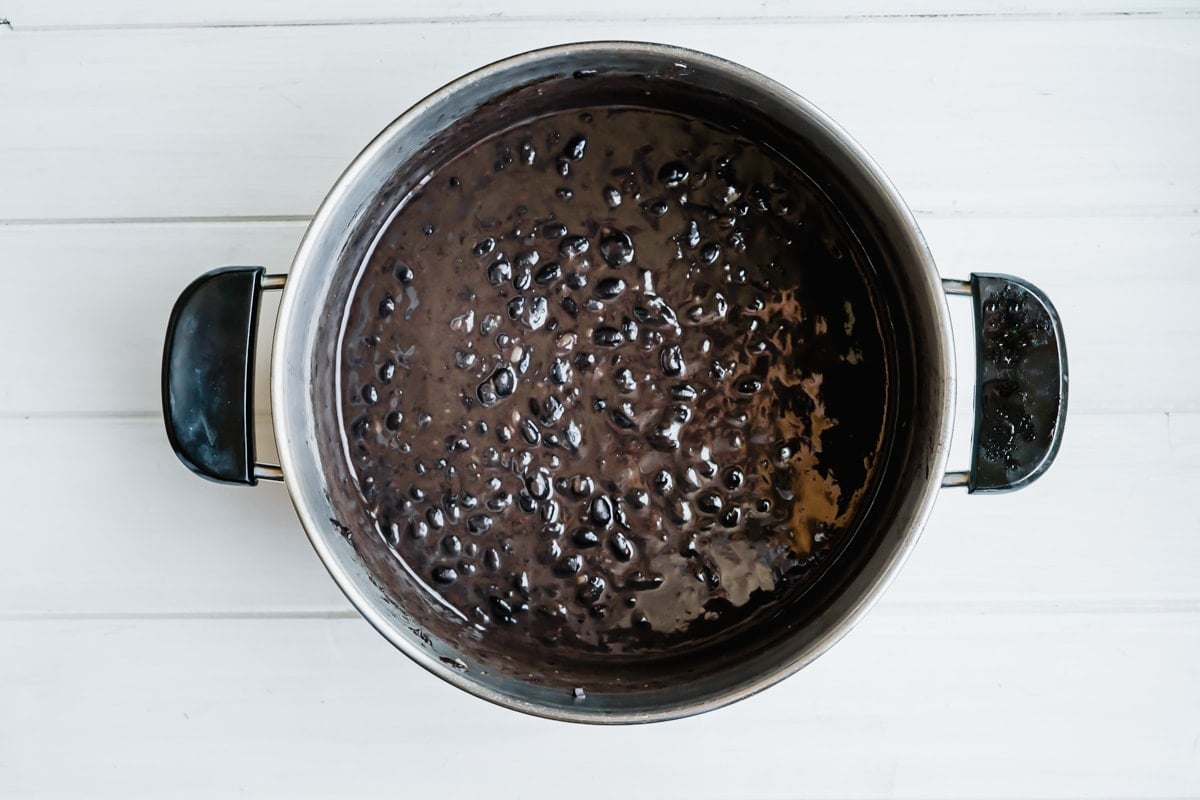 Cooked black beans in a pot.