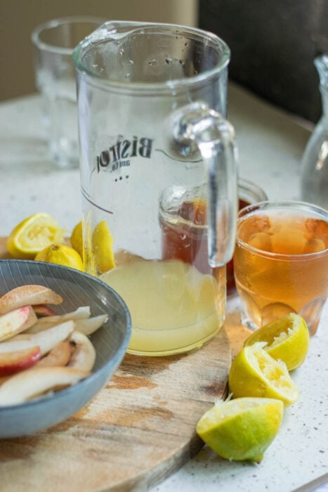 Add ingredients of bourbon punch to a glass pitcher.