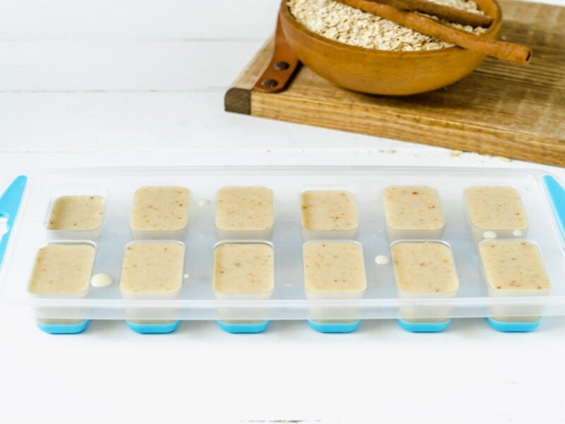 An ice cube tray filled with oat milk