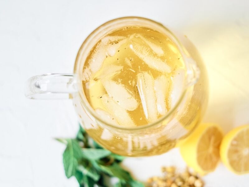 a pitcher of fresh iced chamomile tea, with lemons and mint