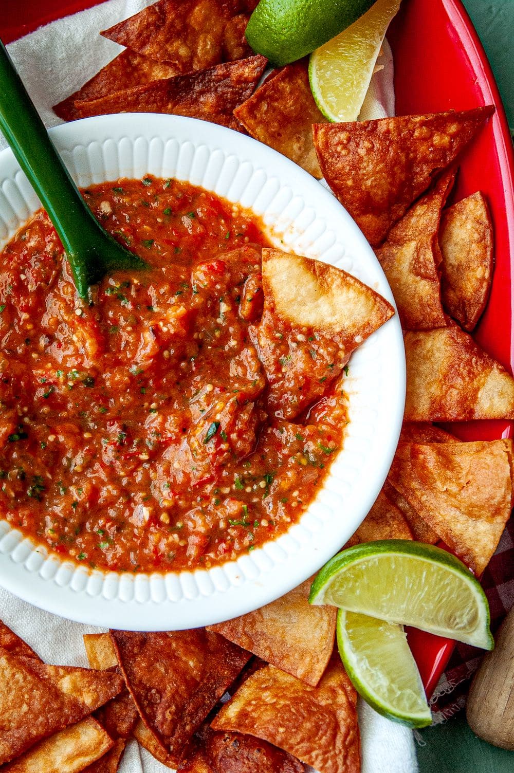 Roasted tomatillo and tomato salsa in a white bowl.