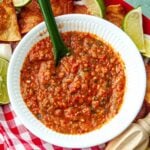 Freezer salsa in a white bowl on a checkered tablecloth.