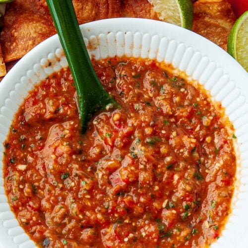 Homemade freezer salsa i a white bowl on a tablecloth.