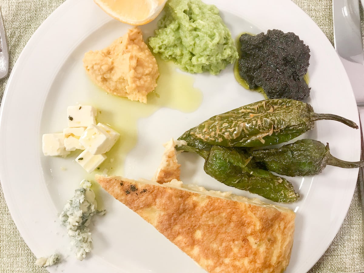 A traditional Spanish breakfast, with several pepper varieties, served on a white plate.