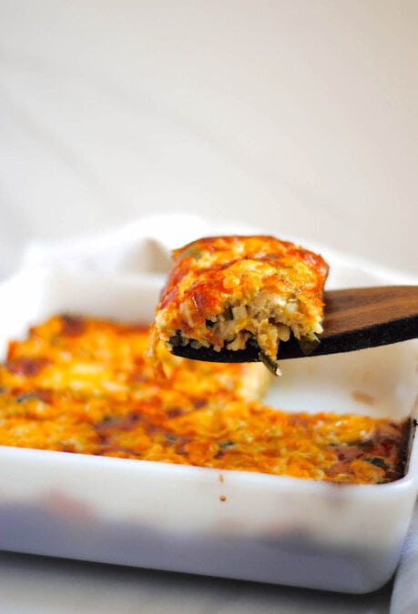 Poblano breakfast casserole being served out of a white baking dish.