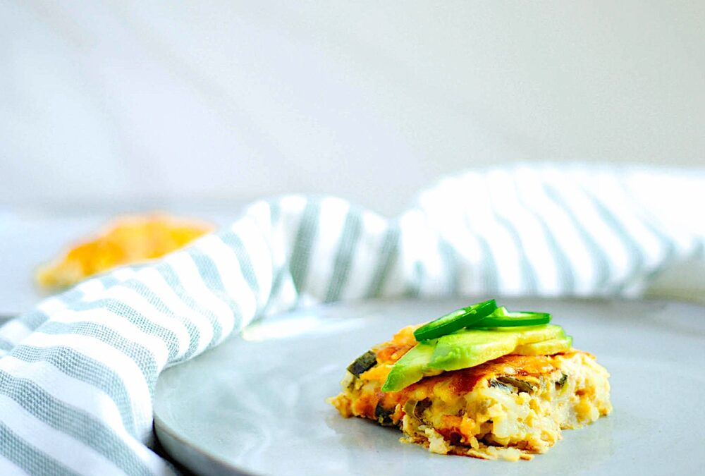 Close-up of breakfast casserole on a blue plate.